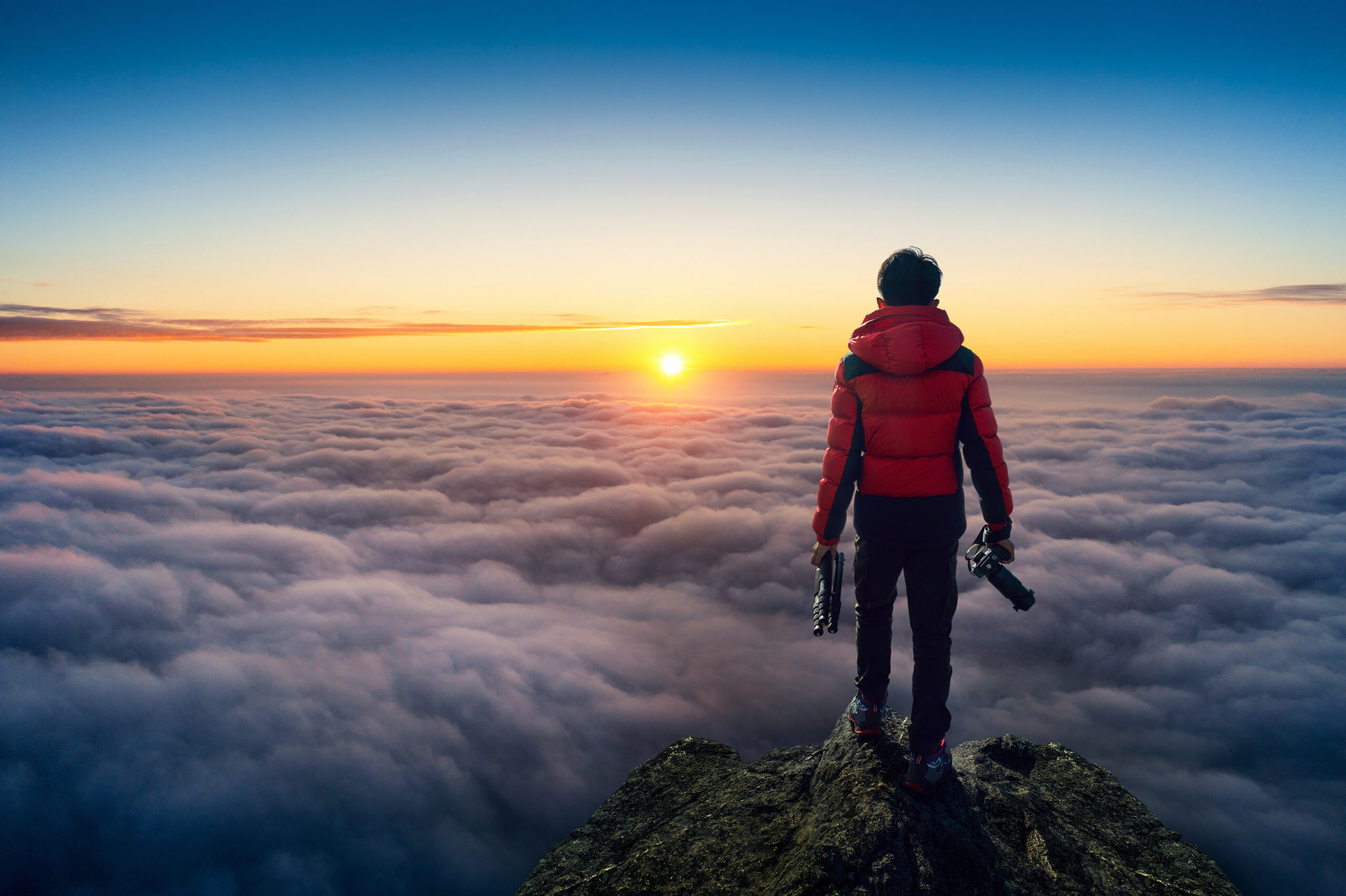 Photographer hand holding camera and standing on viewpoint over
